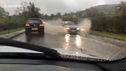 UK man drives through flooded road on his way to work