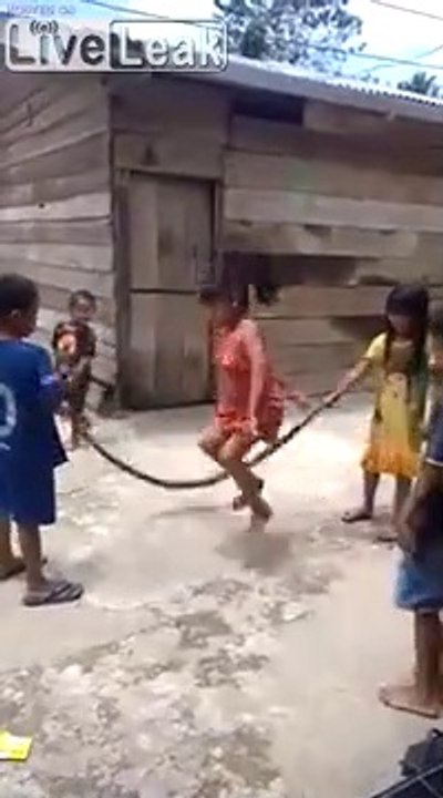 Children playing jump rope with a dead snake