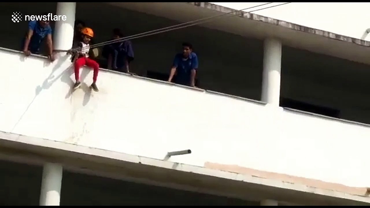 Terrifying moment a young girl falls 30 feet from zip line at Indian school