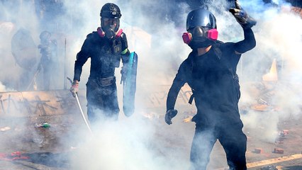 HK police fire tear gas as protesters injure officer with arrow