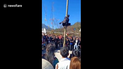 Vietnamese festival sees contestants race to climb up five-metre wooden pole