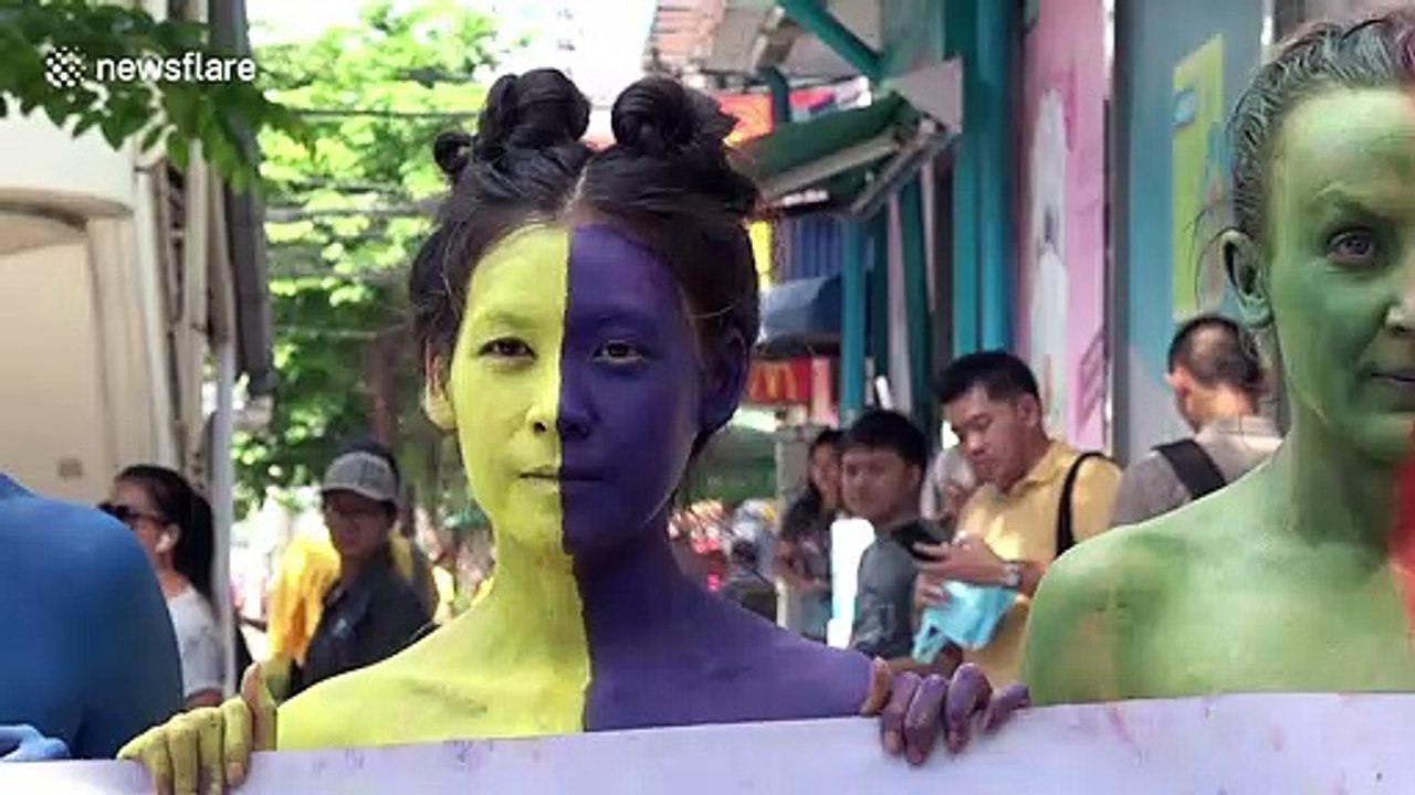 Protesters strip off outside Thai department store that has kept a gorilla on the top floor since 1993