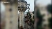 Footage shows controlled demolition of defunct water tank crushing house in western India