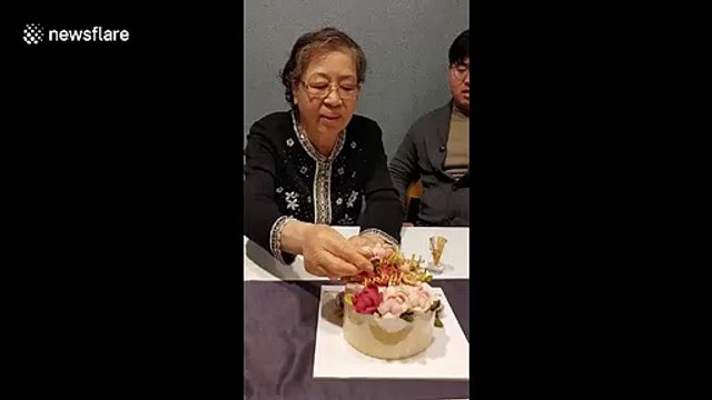 A lot of dough! South Korean grandmother gets endless stream of money inside birthday cake