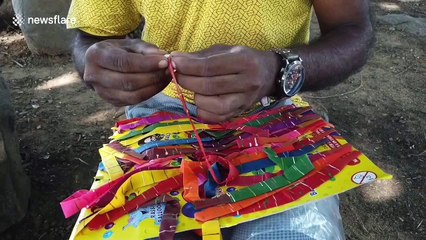 Indian man blows up a balloon with his ear