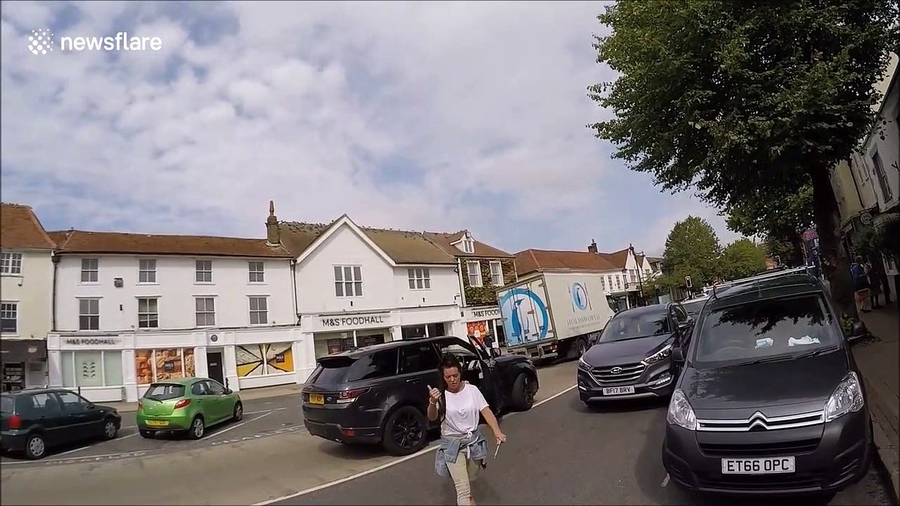 'You're not normal!' Raging motorist confronts cyclist that catches her on phone