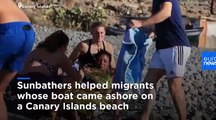 Sunbathers come to aid of exhausted migrants on Gran Canaria beach