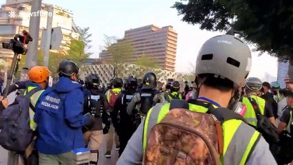 Riot police charge protesters and throw tear gas during legal Hong Kong march