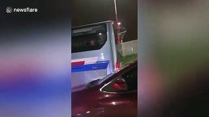 Chinese construction worker joyfully skips on his way home