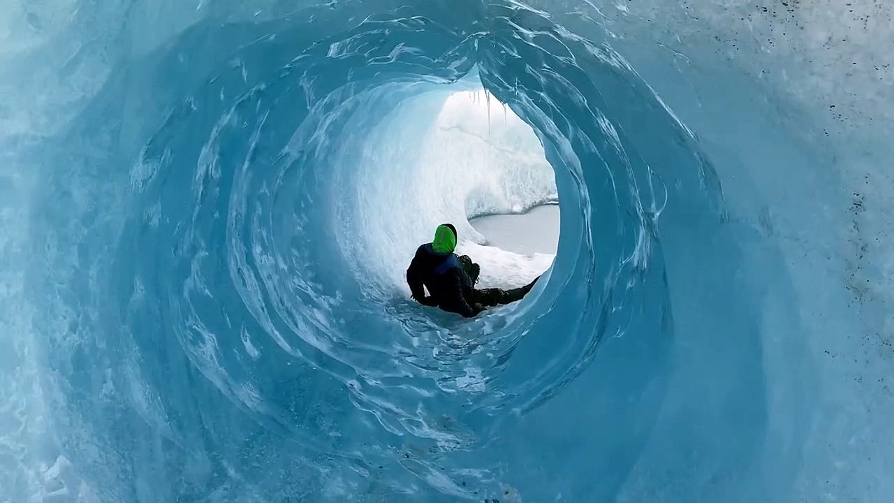 Sliding Through Glacial Ice Cave
