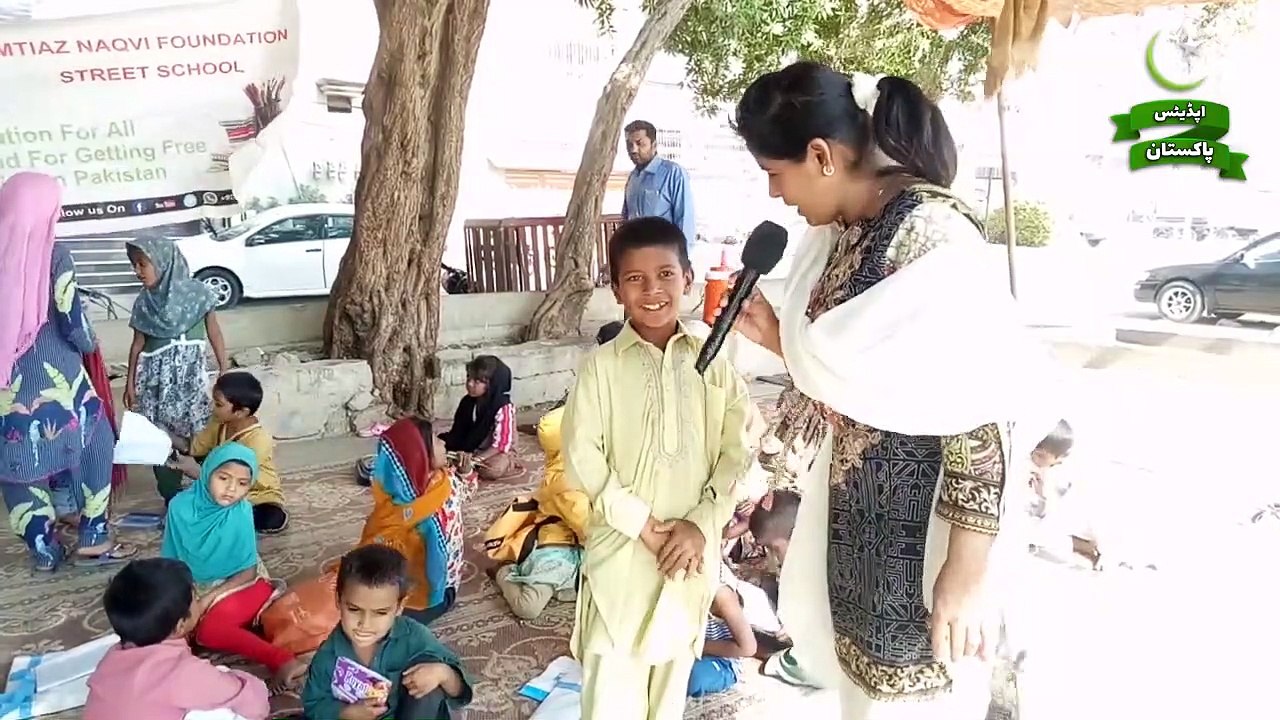 A Young teacher educating small kids of Slum Areas in a Street School of Karachi -- UpdatesPakistan