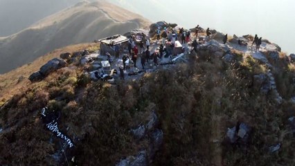Hong Kong protesters unveil banners on mountaintop at dawn