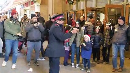 Salvation Army officer dancers with passerby in New York