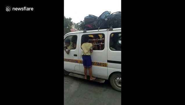 Police arrest school bus driver after boy forced to travel to school hanging from school van