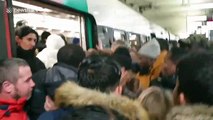 Chaotic scenes as commuters push and shove to board packed train in Paris during nationwide strikes