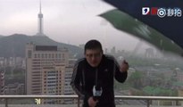 Un rayo le pega en todo el paraguas al reportero chino mientras da el parte meteorológico