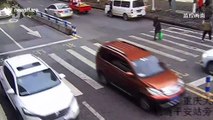 Furious child kicks out at car that knocked over his mother at zebra crossing in China