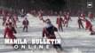 US: Hundreds of Santa Clauses ski down a mountain at charity event