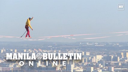 Paris: tightrope walker hovers 150 m above ground, crossing the void between towers in the business district