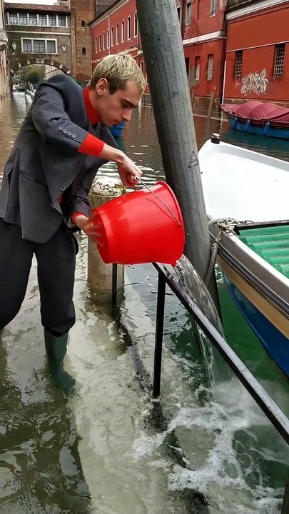 Bailing Out Venice with a Red Bucket