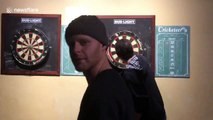 Bullseye! Canadian man makes insane dart throw through friend's fingers