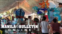 Students of UP Diliman apply finishing touches on their lantern floats for annual lantern parade