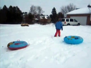Kid Tries To Jump Onto A Tube In The Snow And Fails