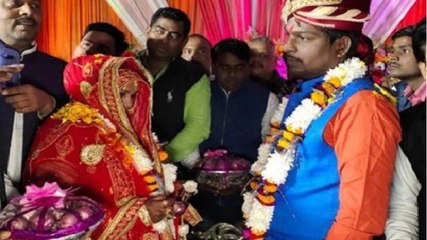 Bride and Groom exchange garlands of onions and garlic