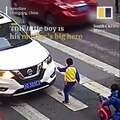 This little boy in China is his mummy's big hero - he vented his anger at a car that sent his mum flying.