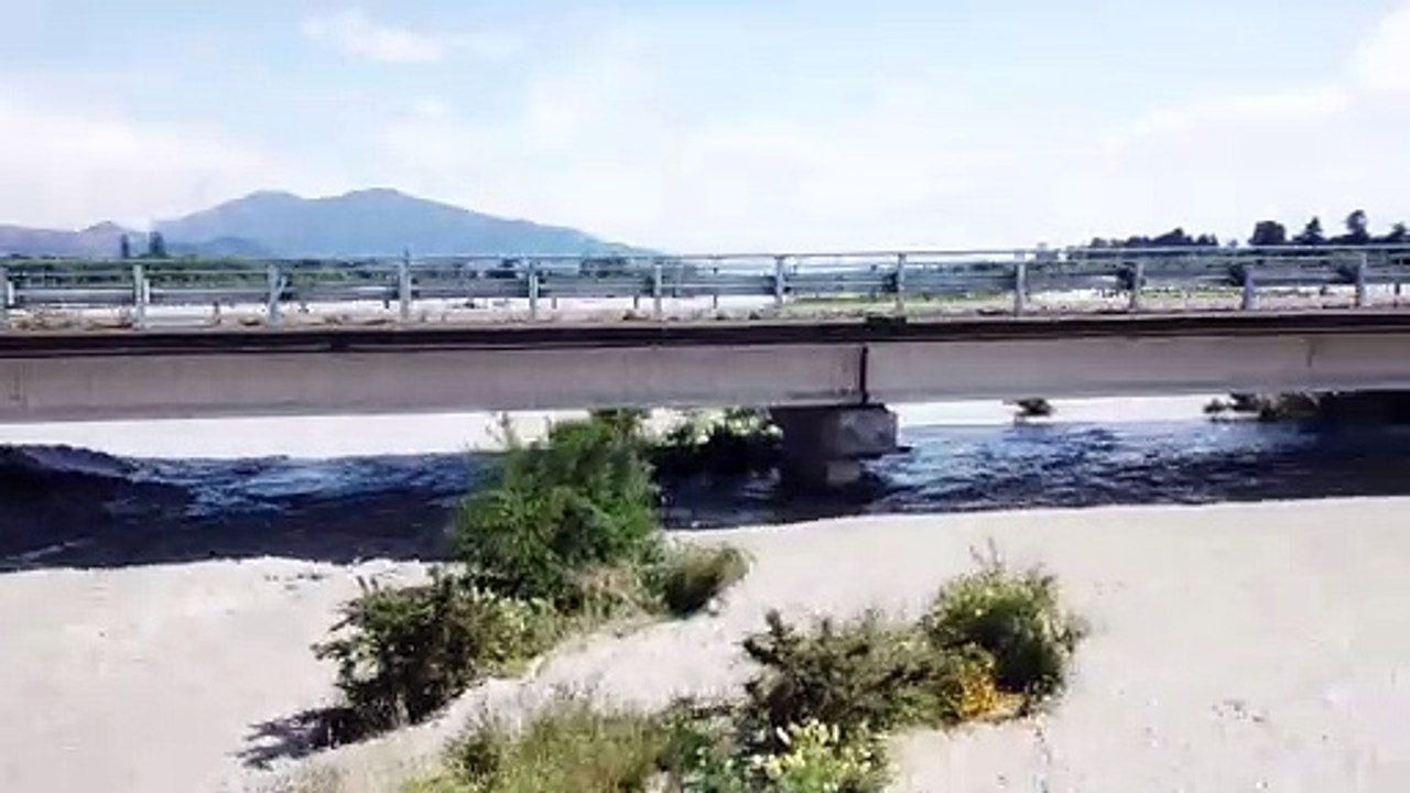 Flooded River Rises To Bridge's Roadway