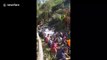 Hundred of locals help pull crashed truck back to mountain top in Thailand