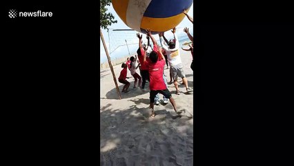 Staff play with giant volleyball for Christmas party in the Philippines
