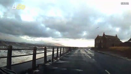 Storm Surge Causes Roadside Waves That Nearly Wash Man and His Son Out to Sea