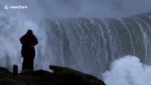 Surfers take to the sea off Nazare to tackle huge 65ft waves