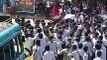 RSS goons throwing soda bottles and plastic containers at school students who...