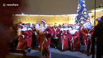 Scores of Santas race around St Petersburg square