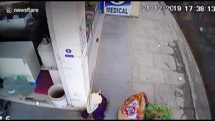 Close kale! Vegetable vendor inches from death when runaway police car grazes her leg