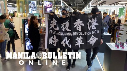 Hong Kong protesters march, scuffle with police in shopping mall