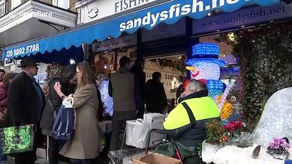 On Christmas Eve, hundreds queue for turkey and festive food in London