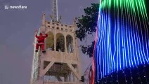 Santa Claus abseils down Thailand cathedral bell tower!