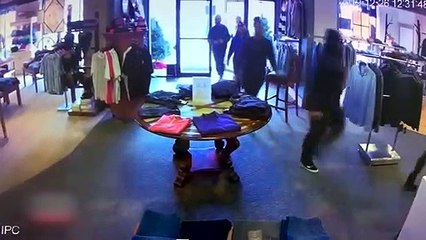 Security Camera: Shoplifters try to steal expensive coats