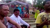 Boy introducing tourists about the holy ground of Varanasi in English