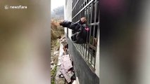 Alleged thief gets stuck between security bars in South China