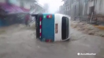 Vicious floodwaters sweep cars away
