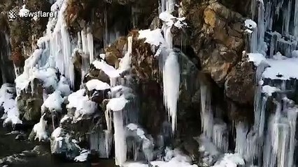 Huge icicles formed at waterfall in Drang Tangmarg, North Kashmir as a result of freezing temperatures