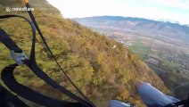 Aerial daredevil parachutes just inches above treetops speed-flying down French mountain