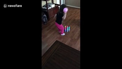 Little girl has unique way of knocking down bowling pins