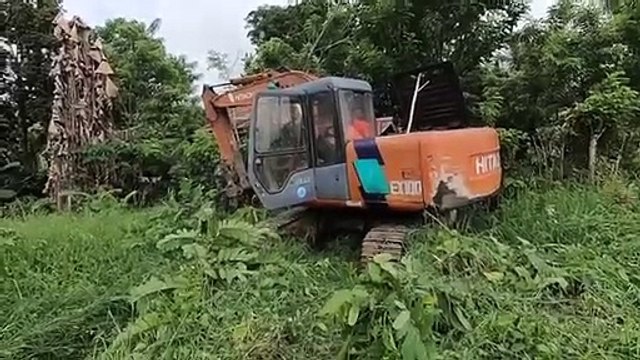 Excavator Excavating In The Farm