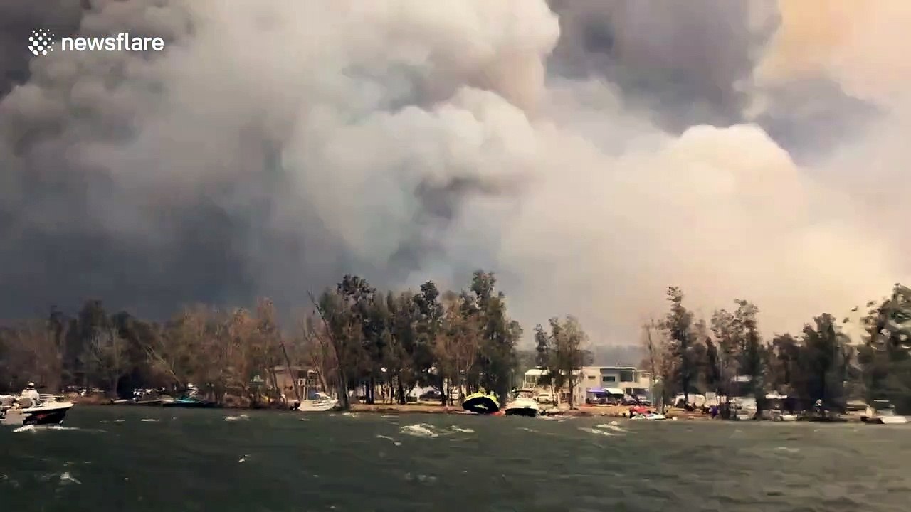 Australians watch their homes burn while evacuating from bushfires on boat