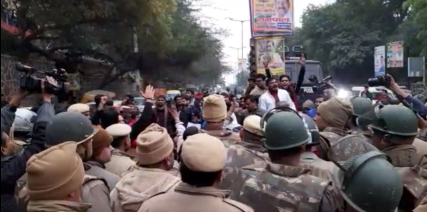 ABVP activists gather outside the JNU main gate from Munirka Village